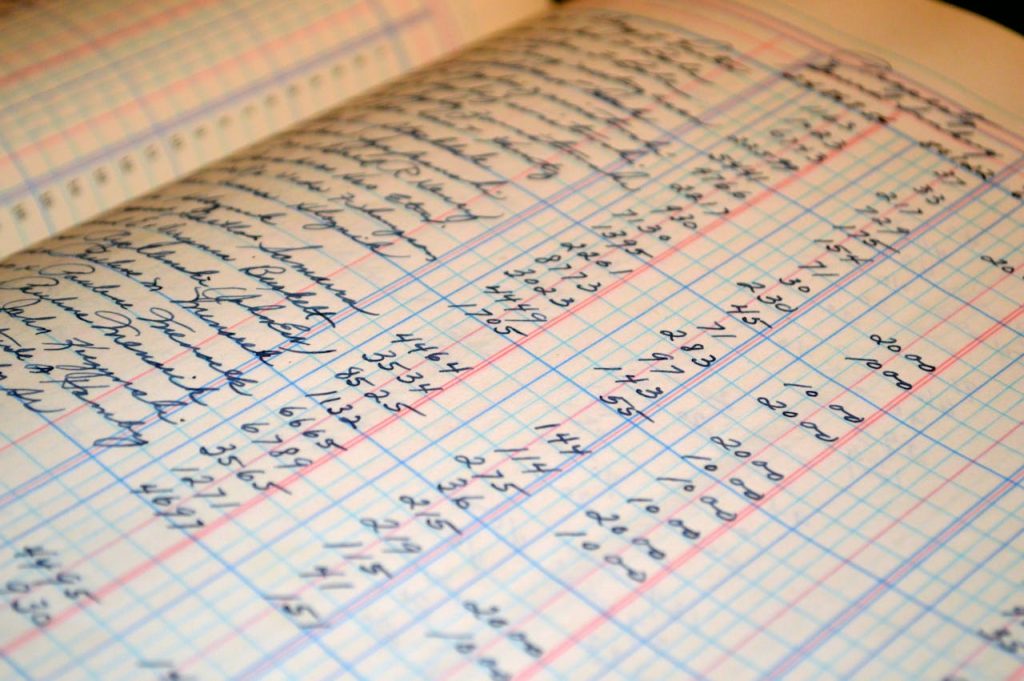 Close-up of a vintage handwritten ledger detailing financial records and accounts.